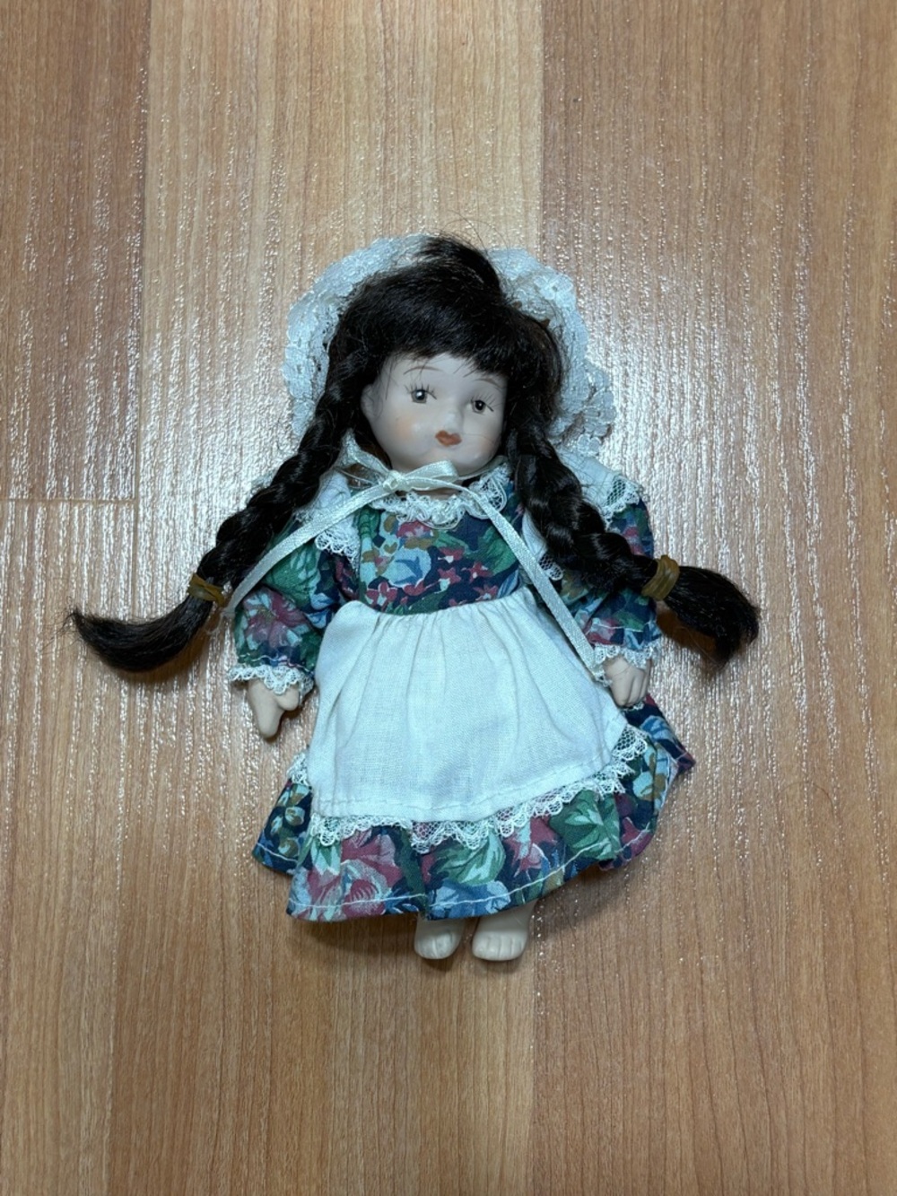 Porcelain Collectible Doll with Floral Dress and White Apron